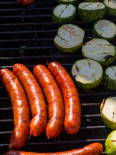 Grilled Sausages. Cheese Sausages Fry On The Grill With Zucchini