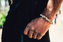Close Up Of Man's Arm With Rainbow Braid Bracelet
