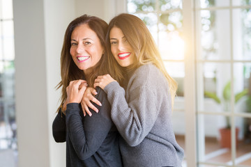 Wall Mural - Beautiful family of mother and daughter together, hugging and kissing at home