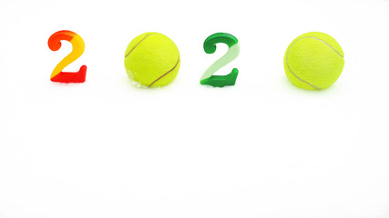 Wall Mural - Tennis Christmas and 2020 New Year concept with tennis balls and numbers on white snow, isolated. Top view, copy space. Winter sport healthy layout. Holiday conception. Banner size.