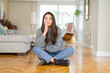 © Krakenimages.com - Young beautiful woman sitting on the floor at home thinking looking tired and bored with depression problems with crossed arms.