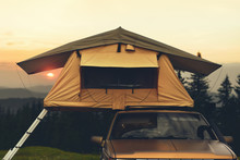 Travel To Mountains On Car With Camping Tent On Roof