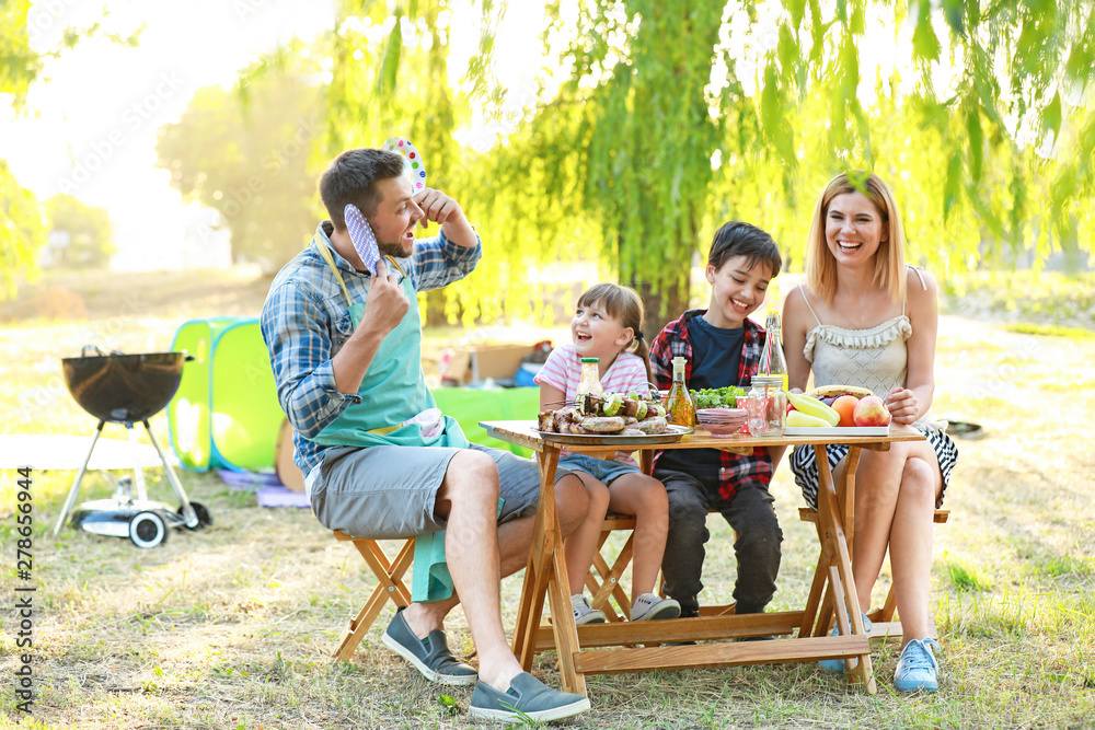 Happy family having picnic on summer day