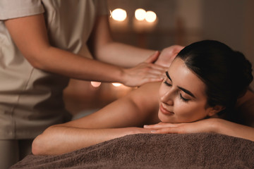 Wall Mural - Beautiful young woman receiving massage in spa salon