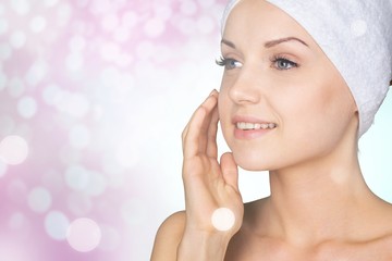 Wall Mural - Portrait of beautiful young woman  in white towel on head on  background