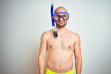 Young Man Wearing Diving Snorkel Goggles Equipent Over Isolated Background With Serious Expression On Face. Simple And Natural Looking At The Camera.