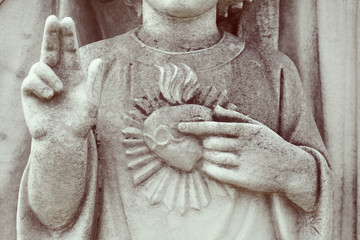 Detail of Holy Family. Young Jesus with sacred heart. Statue depicting Holy Family with child Jesus Christ.