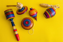 Mexican Toys From Wooden, Balero, Yoyo And Trompo In Mexico On A Yellow Background