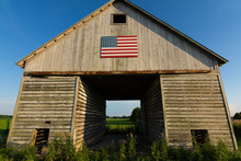 Old Wooden Barn With American Flag