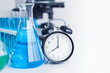 © Quality Stock Arts - Time clock with Chemical Glassware for Medical Science Research in Laboratory
