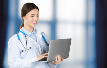 Wall Mural - Portrait of an attractive young female doctor in white coat