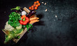 © Storm - Healthy food background. Concept of healthy food, fresh vegetables in box on a dark background