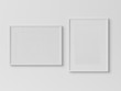 White rectangular frames hanging on a white wall mockup 3D rendering