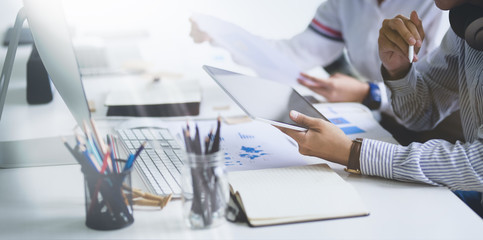Young group of businessman and businesswoman brainstorming their strategy, close up of the hand