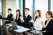 © Tom Wang - Businesspeople applauding while in a meeting