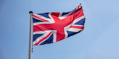 Canvas Print - Great Britain flag waving against clear blue sky