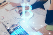 © peshkova - Cryptocurrency hologram over woman's hands writing background. Concept of blockchain. Multi exposure