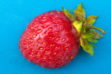 Half a strawberry on a blue background