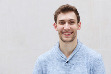 Wall Mural - front portrait of handsome young man smiling and looking at camera