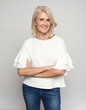 © spaxiax - Pretty middle aged blonde woman is smiling and looking at camera. Isolated