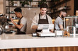 © Drobot Dean - Happy coffee men colleagues in cafe bar working indoors.