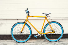 Old Yellow Fixed Gear Bicycle On White Wall Background