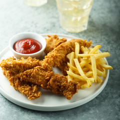 Wall Mural - Homemade fish and chips on white plate