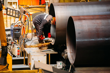 Wall Mural - Male worker grinding butt weld pipe