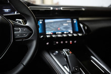 Selective Focus Of Steering Wheel Near Gear Shift Handle In Luxury Car