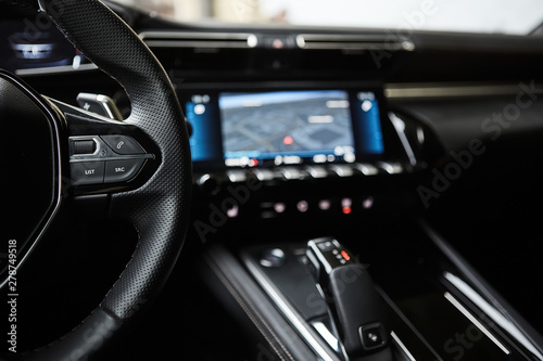 Fotomural selective focus of steering wheel near gear shift handle in luxury car