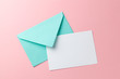 Green envelope and blank letter on pink background. Template with place for text on postcard. mock-up