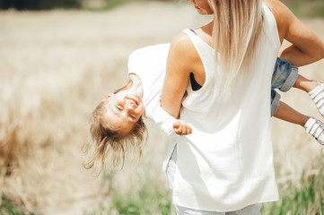 Mother and daughter in wheat field. Mother Day.