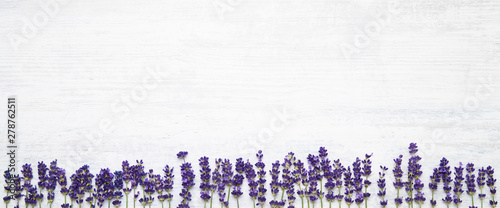 Photo: Lavender flowers border on white background. Copy space, top view. Summer background. Copy space, banner Lavender flowers border on white background. Copy space, top view. Summer background. Copy space, banner