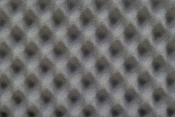 Noise isolating protective and shock, texture. Background of sound absorbing sponge, wall soundproofing. Recording studio sound dampening acoustical foam, background.