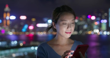 Poster - Woman use of mobile phone in city of Hong Kong at night