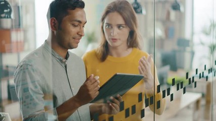 Aufkleber - Portrait of Handsome Indian Man Showing Touch Screen Digital Tablet Computer To His Beautiful Female Team Member, They Discuss Project Details. Successful Young People Working in Diverse Office