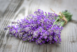 Fototapeta Lawenda - Bouquets of lavender on wooden background. Medicinal plants. Aromatherapy.