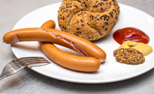 Fresh Boiled Vienna Sausages Or Frankfurter Wurstchen Served Simply With Kaiser Rolls, Ketchup And Mustard On White Plate