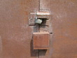 Lock on an old rusty iron door. Old rusty metal grunge background.
