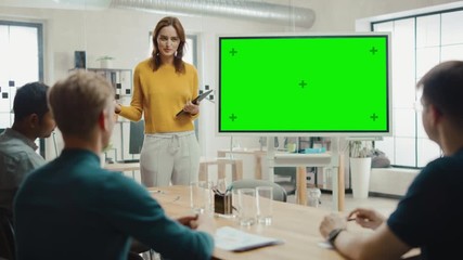 Poster - Female Project Manager Holds Meeting Presentation for a Team of Developers. She Shows Green Screen Interactive Whiteboard Device for Business Planning Concept. Young People Work in Creative Office