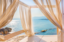 Sea View Through The Curtains Of A Luxurious Bed On The Beach