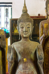 Wall Mural - Lan Chang Buddha statue art in various temples in Luang Prabang, Laos.