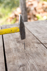 To hammer a nail with a hammer.