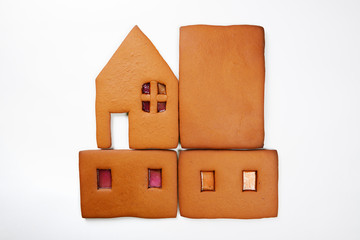 The hand-made eatable gingerbread parts of house on white background