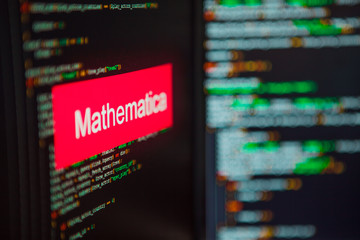 programming language, mathematica inscription on the background of computer code.