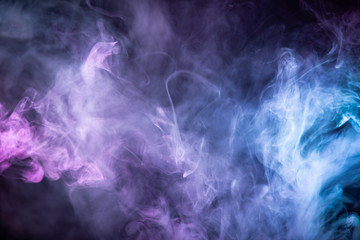 Wall Mural - Abstract colorful smoke on black background .