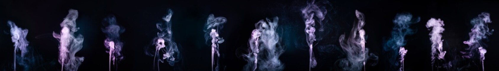 Wall Mural - Abstract colorful smoke on black background .