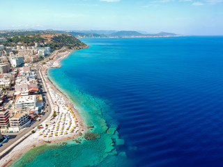 Wall Mural - Aerial birds eye view drone photo of Elli beach on Rhodes city island, Dodecanese, Greece. Panorama with nice sand, lagoon and clear blue water. Famous tourist destination in South Europe