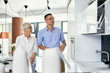 © Westend61 - Man and mature woman talking in a kitchen retail store