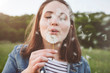 © Westend61 - Portrait of teenage girl blowing dandelion